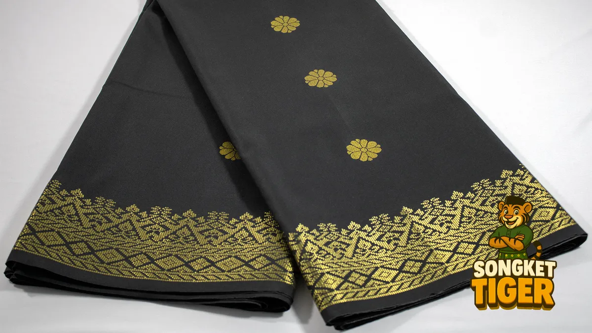 Close-up of songket fabric showing gold thread motifs woven into the cloth