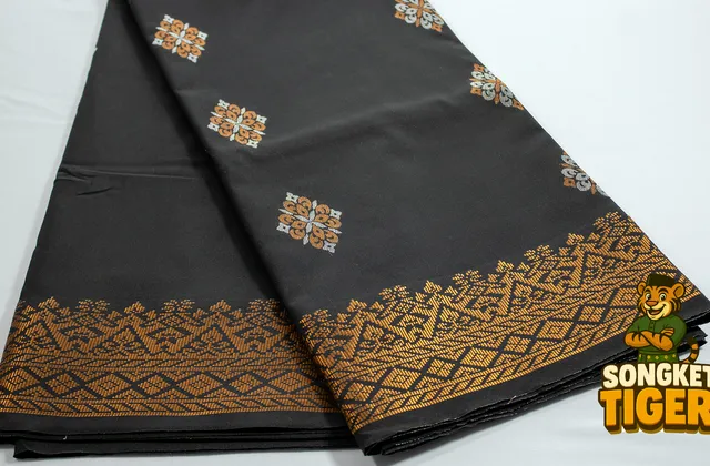 Close-up of songket fabric texture showing the base weave and gold thread